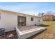 View of the backyard featuring a patio and a bright, painted-brick exterior at 2232 Glenraven Ave, Gastonia, NC 28052