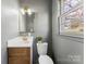 Bathroom vanity featuring a sink, mirror, and modern lighting at 2232 Glenraven Ave, Gastonia, NC 28052