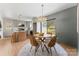 Bright dining area features modern chandelier, table and seating near kitchen with sliding door to exterior at 2232 Glenraven Ave, Gastonia, NC 28052