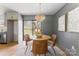 Bright dining area features modern chandelier, table and seating near kitchen with sliding door to exterior at 2232 Glenraven Ave, Gastonia, NC 28052