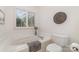 Bright bathroom featuring a white jacuzzi tub with window and tile surround at 2320 Christensens Ct, Charlotte, NC 28270