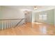 Large bonus room with hardwood flooring, natural light, and staircase at 2320 Christensens Ct, Charlotte, NC 28270