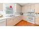 Bright kitchen featuring white appliances and wood flooring at 2320 Christensens Ct, Charlotte, NC 28270