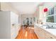 Kitchen featuring white appliances, ample cabinets, and hardwood floors at 2320 Christensens Ct, Charlotte, NC 28270