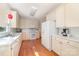 Bright kitchen featuring white appliances and wood flooring at 2320 Christensens Ct, Charlotte, NC 28270