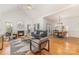 Bright living room featuring vaulted ceiling, hardwood floors, gas fireplace, and an open dining area at 2320 Christensens Ct, Charlotte, NC 28270