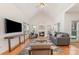 Bright living room featuring vaulted ceiling, hardwood floors, gas fireplace, and large windows at 2320 Christensens Ct, Charlotte, NC 28270