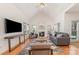 Bright living room featuring vaulted ceiling, hardwood floors, gas fireplace, and large windows at 2320 Christensens Ct, Charlotte, NC 28270