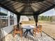 Cozy backyard patio featuring a gazebo with a round table and chairs on a stone tile at 2437 Grinstead Ct, Clover, SC 29710