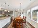 Inviting dining room with dark wood floors, decorative rug, and natural light from a large window at 2437 Grinstead Ct, Clover, SC 29710