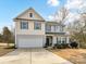 Charming two-story home featuring a two-car garage and a well-manicured lawn at 2437 Grinstead Ct, Clover, SC 29710