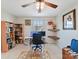 Bright office space with bookshelves, desk, ceiling fan and decoratively framed artwork at 2437 Grinstead Ct, Clover, SC 29710