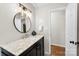 Updated bathroom with marble countertop, modern fixtures, and large round mirror at 2500 Danforth Ln, Charlotte, NC 28208