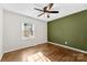 This bedroom features hardwood floors and a large window at 2500 Danforth Ln, Charlotte, NC 28208