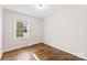 This bedroom has wood floors, neutral paint and a window looking out to the yard at 2500 Danforth Ln, Charlotte, NC 28208