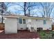 Charming home exterior featuring white painted brick, a back entrance, and well-maintained landscaping, offering a timeless appeal at 2500 Danforth Ln, Charlotte, NC 28208