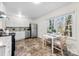 Bright kitchen featuring white cabinets, stainless steel appliances, and a cozy dining area at 2500 Danforth Ln, Charlotte, NC 28208