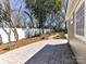 Backyard featuring stamped concrete patio, white privacy fence and mature landscaping at 2919 Park Rd, Charlotte, NC 28209