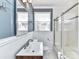 Elegant bathroom featuring tub/shower combo, sink with dark wood vanity and modern mirror at 2919 Park Rd, Charlotte, NC 28209