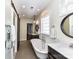 Well-lit bathroom with walk-in shower, standalone tub, dual sink vanity and barn door at 2919 Park Rd, Charlotte, NC 28209