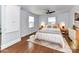 This staged bedroom features hardwood floors, neutral walls, and a ceiling fan at 2919 Park Rd, Charlotte, NC 28209