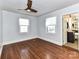 Bright bedroom with hardwood floors, modern ceiling fan, and plenty of natural light at 2919 Park Rd, Charlotte, NC 28209