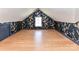 Bonus room featuring wood floors and decorative wallpaper at 2919 Park Rd, Charlotte, NC 28209