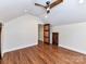 Bonus room with hardwood floors, rustic doors and access to the attic crawlspace at 2919 Park Rd, Charlotte, NC 28209