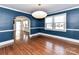 A blue dining room featuring hardwood floors, and an open doorway at 2919 Park Rd, Charlotte, NC 28209