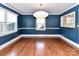 A blue dining room featuring hardwood floors, with crown molding and trim at 2919 Park Rd, Charlotte, NC 28209