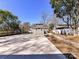 Long concrete driveway leading to a spacious backyard and detached garage in the rear at 2919 Park Rd, Charlotte, NC 28209