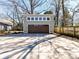 Detached two-car garage with dark wood doors and ample parking in the front driveway at 2919 Park Rd, Charlotte, NC 28209