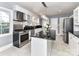 Bright kitchen features stainless steel appliances, black countertops, and marble tile floors at 2919 Park Rd, Charlotte, NC 28209