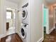 Convenient laundry area featuring stacked washer and dryer units near the bathroom at 2919 Park Rd, Charlotte, NC 28209