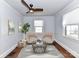 Cozy living room featuring two comfortable chairs, modern ceiling fan, and stylish area rug at 2919 Park Rd, Charlotte, NC 28209