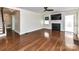 A spacious living room featuring a fireplace, hardwood floors, and a ceiling fan at 2919 Park Rd, Charlotte, NC 28209