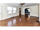 An open-concept living room featuring a arched doorway to another room and hardwood floors at 2919 Park Rd, Charlotte, NC 28209