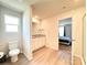 A bright bathroom with a granite countertop vanity, white cabinets, and luxury vinyl flooring at 3122 Maple Ridge Dr, Gastonia, NC 28052