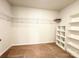 Spacious walk-in closet with adjustable shelving units and neutral carpeting at 3122 Maple Ridge Dr, Gastonia, NC 28052