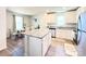 Bright kitchen with an island featuring granite countertops, white cabinetry, and stainless steel appliances at 3122 Maple Ridge Dr, Gastonia, NC 28052