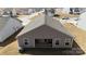 Aerial view of the home's rear exterior, featuring a covered patio, and view of the surrounding neighborhood at 3122 Maple Ridge Dr, Gastonia, NC 28052