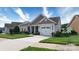 Inviting home featuring a two-car garage, a covered front porch, and a lush green lawn at 313 Garner Dr, Salisbury, NC 28146