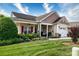 Attractive home with a welcoming porch, a one car garage, and beautiful garden beds at 313 Garner Dr, Salisbury, NC 28146