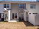 Exterior view of a townhome backyard showing a small patio and fencing at 3209 Blythe Ridge Ct, Charlotte, NC 28213