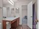 Bright bathroom featuring wood-look flooring, large mirror, single sink vanity, and view to a bedroom at 3209 Blythe Ridge Ct, Charlotte, NC 28213