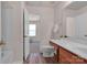 Well-lit bathroom with wood-look floors, single sink vanity and neutral walls adjacent to the toilet at 3209 Blythe Ridge Ct, Charlotte, NC 28213