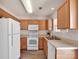 Efficient kitchen space featuring wood cabinets, white appliances, and natural light at 3209 Blythe Ridge Ct, Charlotte, NC 28213