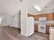 Well-lit kitchen featuring classic wood cabinetry and white appliances with hardwood floors at 3209 Blythe Ridge Ct, Charlotte, NC 28213