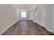 Open-concept living room featuring wood floors, ample natural light, and stairs to the second story at 3209 Blythe Ridge Ct, Charlotte, NC 28213