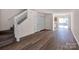 Open-concept living room featuring hardwood flooring, staircase, and natural light from sliding doors at 3209 Blythe Ridge Ct, Charlotte, NC 28213